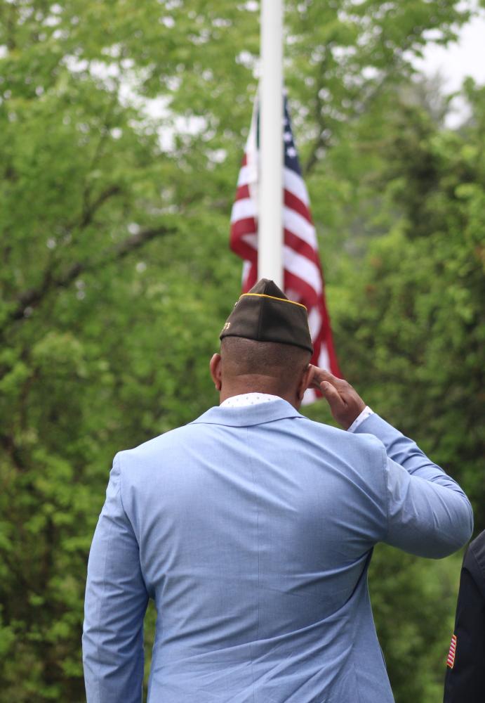 Onset VFW Post commander Benjamin Baptise salutes the flag.