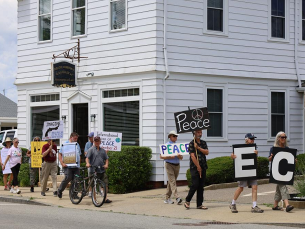 Wareham Faith in Action members hold signs during a June peace walk along Main St. File photo