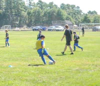 A player passes the ball in a warmup drill.