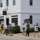 Wareham Faith in Action members hold signs during a June peace walk along Main St. File photo