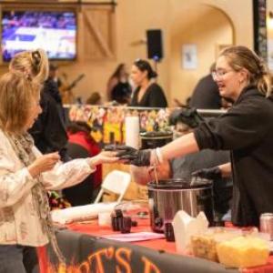 Bella Shephard of Arts BBQ in Middleboro dishes out some chili in 2025. File photo