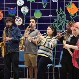 Wareham alumna Sophia Maniglia, center, performs with other students and music teacher Jason Roth, to her left. Photos by Nick Mossman