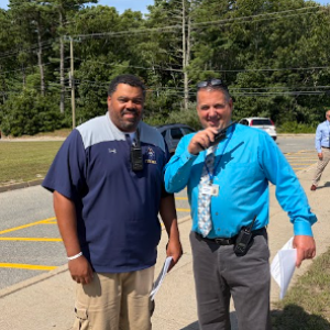 Coach Stephen Faniel and Principal Scott Palladino see off kids after the first day of school. Photo by Christian Uva