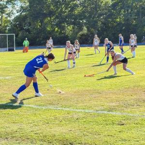 A field hockey player hits the ball during the 4-0 loss. Photo by Christian Uva