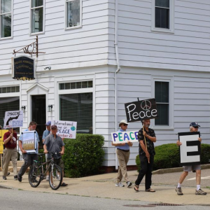 Wareham Faith in Action members hold signs during a June peace walk along Main St. File photo