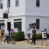 Wareham Faith in Action members hold signs during a June peace walk along Main St. File photo